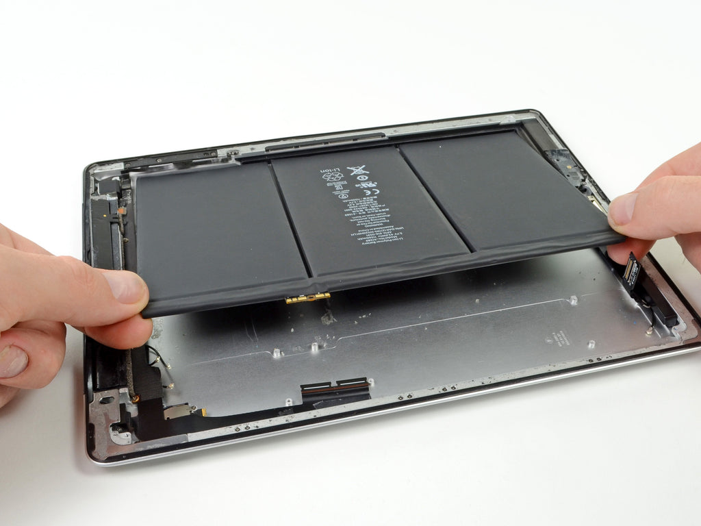 Tablet internals shown in context on a repair bench